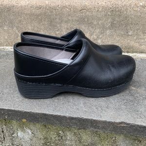 Danskos black leather clogs